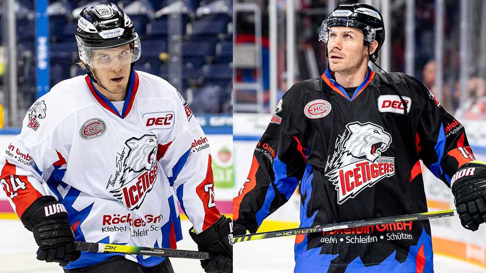 Eishockeyspieler in weißen und schwarzen Trikots auf dem Eis.