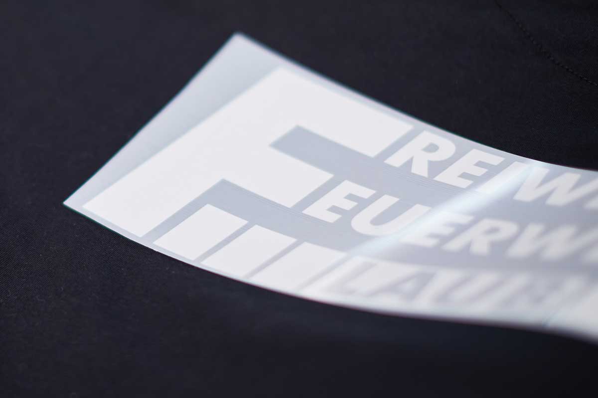 Flexprints Druck auf schwarzem Stoff, Nahaufnahme.